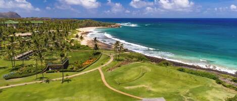 A golf course with a view of the ocean and a beach.
