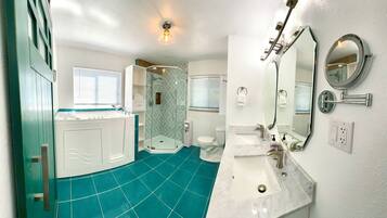 A bathroom with a shower, toilet, and sink.