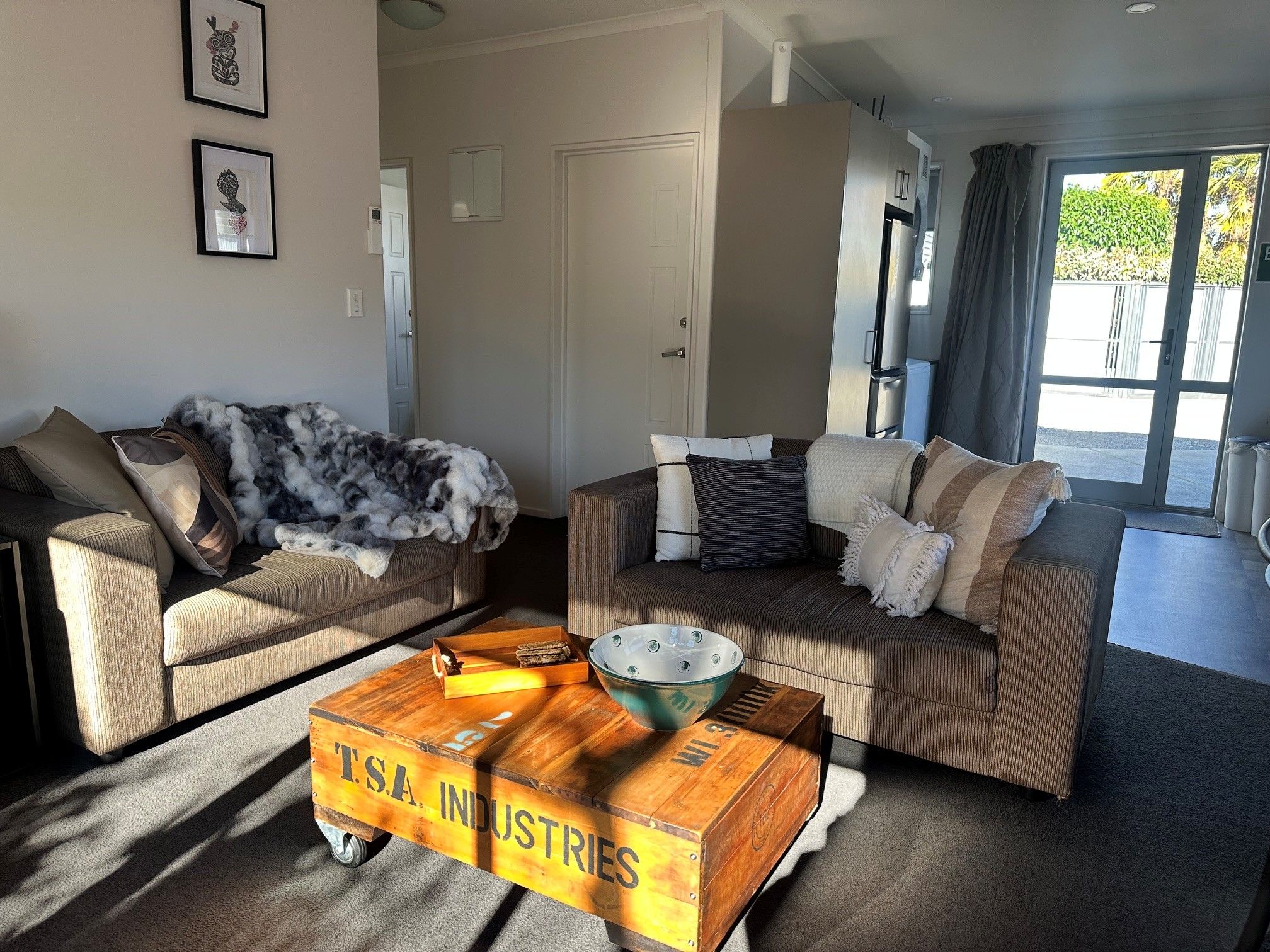A living room with two sofas, a coffee table, and a decorative wooden box.