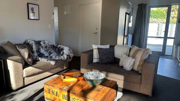 A living room with two sofas, a coffee table, and a decorative wooden box.