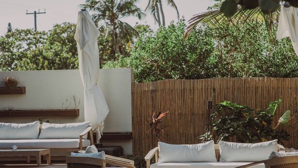 A pool area with lounge chairs and a wooden deck.