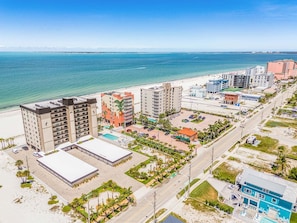 A coastal hotel with multiple buildings, a beach, and a parking lot. - Beachfront Sunsets, Heated Pool & Gulf Views Escape - Dolphin Watch 203 - Roelens (Fort Myers Beach)