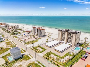 A coastal hotel with multiple buildings, a swimming pool, and a beach view. - Beachfront Sunsets, Heated Pool & Gulf Views Escape - Dolphin Watch 203 - Roelens (Fort Myers Beach)
