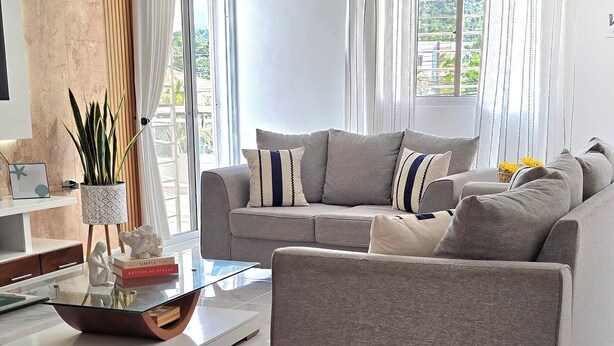 A modern living room with a sofa, a coffee table, and a ceiling fan. - NO BLACK OUT OR OUT OF POWER. Power Inverter System.
3 Bedroom with A/C/2 bath (Puerto Plata)