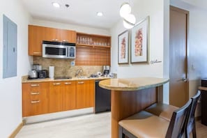 A compact kitchen with wooden cabinets, a microwave, a coffee maker, and a sink. - ★ EXCLUSIVE Luxury Studio with FREE Parking ★ (Miami)