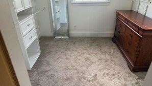 A room with a walk-in closet, a dresser, and a window. -     Relax & Unwind Stylish Decatur Home Near Downtown ATL (Decatur)