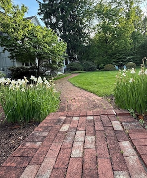 A brick pathway leading to a house with a lawn and trees. - Distinctive 4-Bed 4.5 Bath Victorian Home in Beautiful Summit NJ. Fully Updated. (Summit)