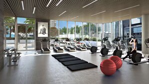 Ein modernes Fitnessstudio mit Laufbändern, Ergometer und Fitnessbällen.