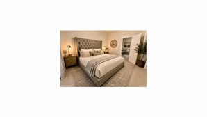 A bedroom with a large bed, nightstands, a wall clock, and a potted plant. - Updated, Spacious TWHM - Close to Everything - Sleeps 8 - 5min to DFW airport (Irving)