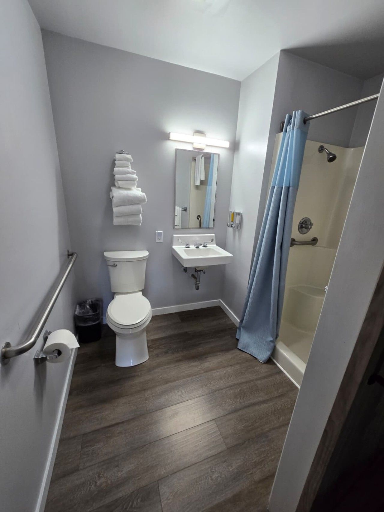 A bathroom with a toilet, sink, and shower.