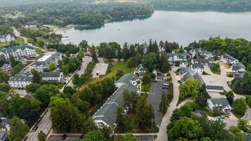 A residential area with houses, roads, and a lake.
