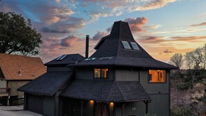 A two-story house with a steeply pitched roof, skylights, and a chimney. - 3-BEDROOM, 3-BATH ARCHITECTURAL MARVEL IN LAKE ARROWHEAD (Lake Arrowhead)