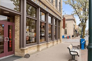 A building with a sign reading 'BREWING CO.' and 'BREW PUB' on the facade. - The Grove 11 | 2BR | Rooftop Patio | Downtown (Traverse City)