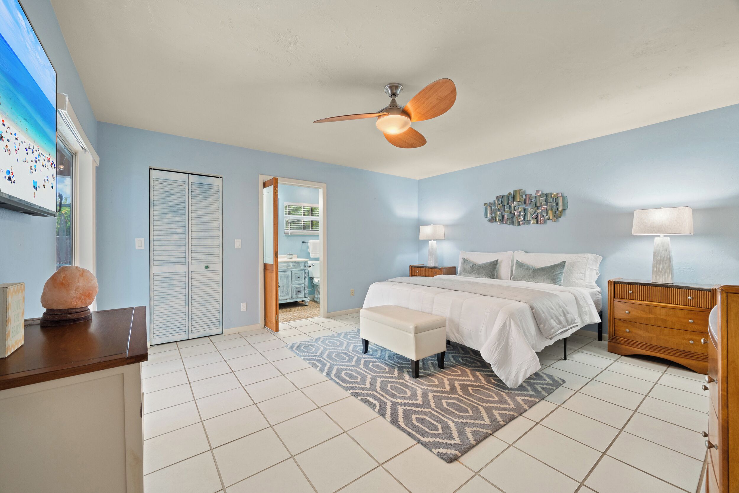 Spacious king primary suite designed for comfort and relaxation after a day at the beach.