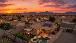 A residential area with houses, a swimming pool, and a mountainous backdrop. - Luxury Private Pool & Spa Home | Resort Backyard | Sleeps 10 (Tucson)