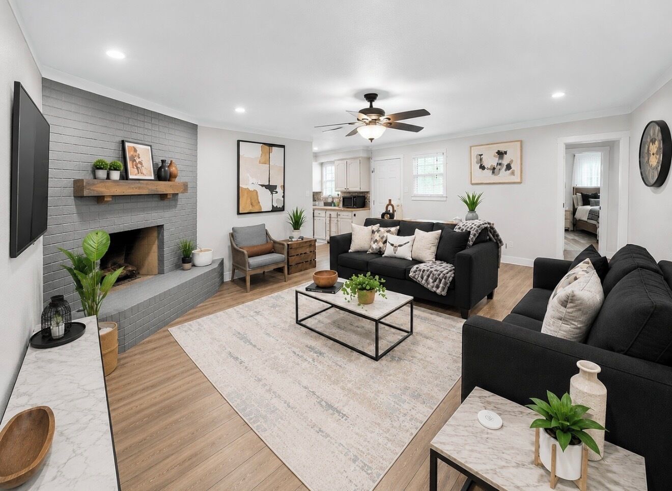 A living room with a fireplace, sofa, coffee table, and a TV.