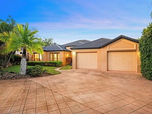 A residential property with a driveway, garage, and well-maintained landscaping. - Artistic Retreat | Privacy Pool Patio WFH Perfect (Parkinson)