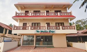 A multi-story building with a sign for 'The Waters Edge Beach Resort.' - OYO 6031 The Waters Edge Beach Resort (Neyyattinkara)