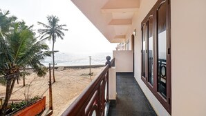A balcony with a view of the beach and ocean. - OYO 6031 The Waters Edge Beach Resort (Neyyattinkara)