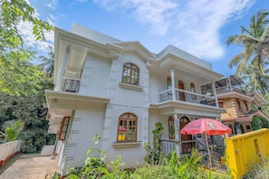 A two-story building with multiple balconies and arched windows. - The Sequeira By Madhu And Sons (Majorda)