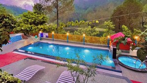 A swimming pool with a view of a mountainous landscape.