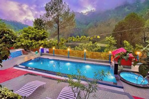 A swimming pool with a view of a mountainous landscape.