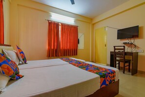 A hotel room with two beds, a desk, a chair, a television, and a window with curtains. - Collection O 81451 Capital Casa (Barasat)