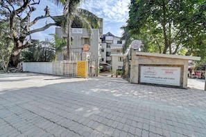 A gated entrance to a hotel with a signboard displaying the name 'DOVES' and 'KOHINOOR EXOTICA HOTELS & RESORTS'.