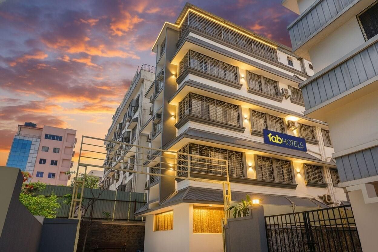 A multi-story hotel with a modern facade, balconies, and a sign indicating it is a FabHotels property.