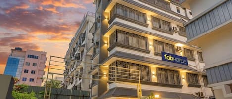 Un hotel de varios pisos con fachada moderna, balcones y un letrero que indica que es una propiedad de FabHotels.