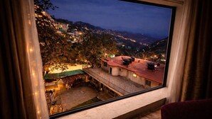 A view from a window overlooking a hillside with buildings and a courtyard. - Ab S Abode A Boutique Hotel (Dehradun)