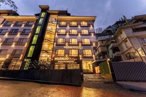 A building with a sign reading 'MEDALIO Boutique' on the ground floor, indicating a boutique hotel. - Medalio Boutique Orbit International (Gangtok)
