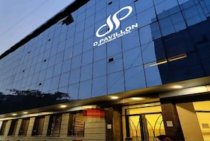 A modern building with a glass facade and a logo for 'D. Pavillon Boutique Hotel' on the upper part. - D Pavillon Boutique Hotel Delhi Airport (New Delhi)