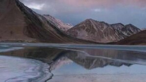 A mountainous landscape with a calm lake reflecting the mountains. - Padma Cottage Pangong (Leh)