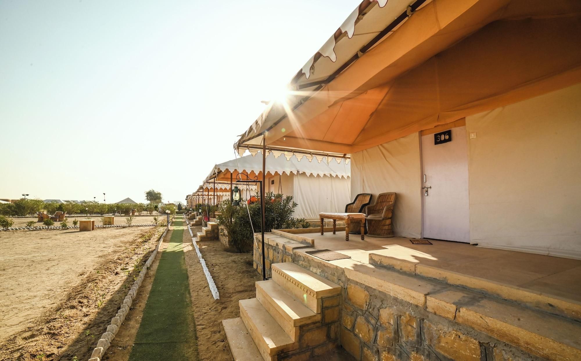 A desert-style tent with a stone staircase leading to a covered porch, outdoor seating, and a number sign on the door.