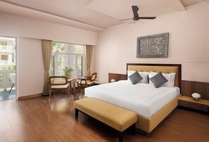 A hotel room with a large bed, a desk, a chair, and a bench. - Kumbhalgarh Valley Resort Kumbhalgarh (Kumbhalgarh)
