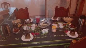 A dining table set with various dishes, glasses, and a coffee pot.