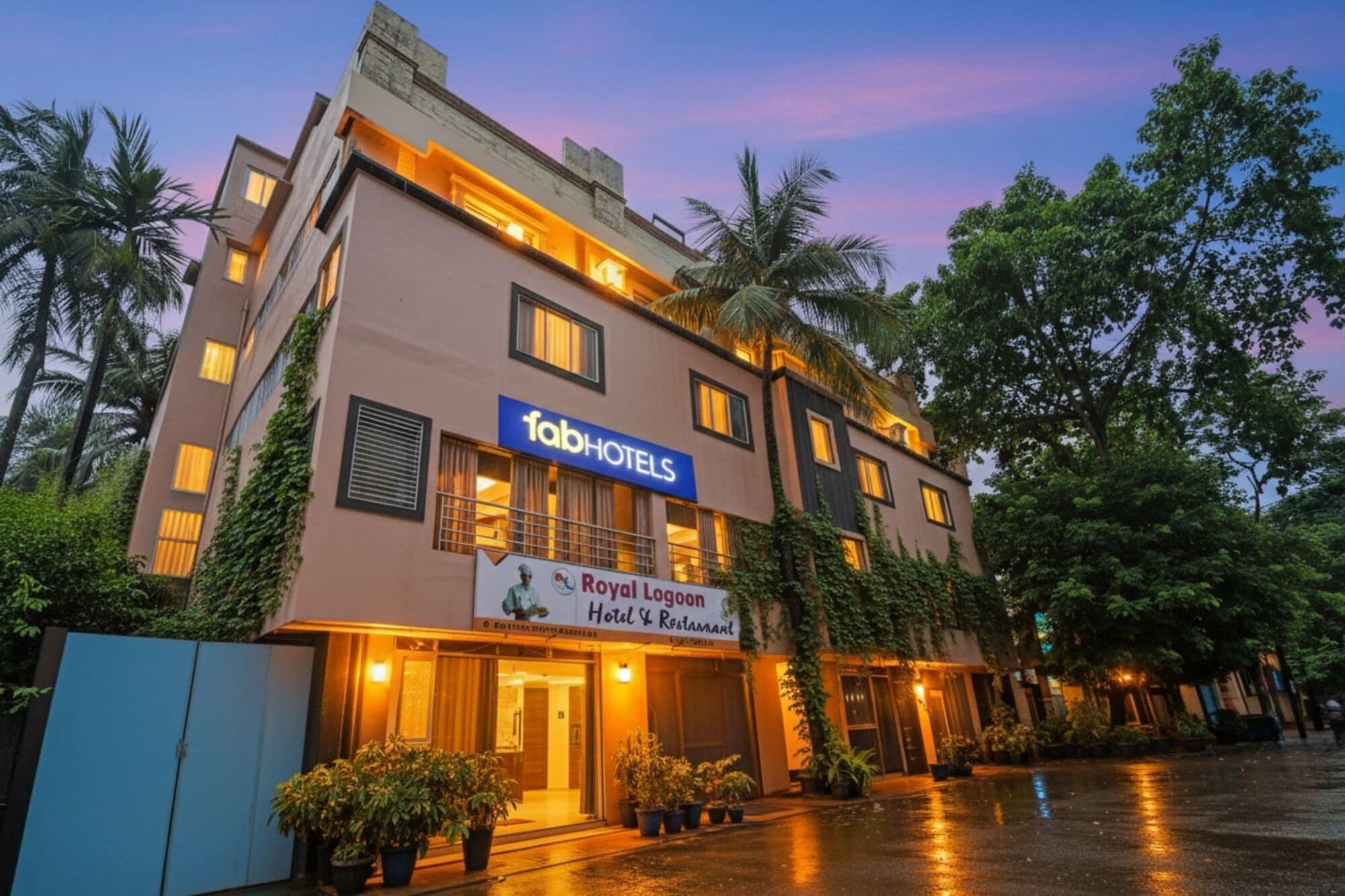 Un hotel con un cartel que dice 'fabHOTELS' y 'Royal Lodge Hotel & Restaurant'.
