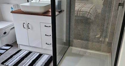 Mudbrick self contained studio with wood heater