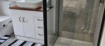 Mudbrick self contained studio with wood heater