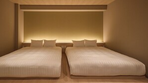 A double bed with a headboard, two bedside tables, and a neutral wall color.