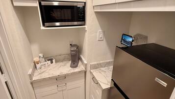 Fridge, microwave, coffee/tea maker, cookware/dishes/utensils