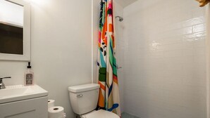 Ein Badezimmer mit Toilette, Waschbecken und Duschvorhang.