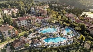 A resort with multiple buildings, a central pool area, and surrounding greenery. - 2BR Villa @ Newport Coast Villas ~ Full Resort Access (Newport Beach)