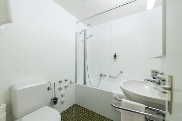 Ein modernes Badezimmer mit Dusche, Toilette und Waschbecken.