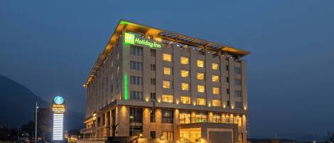 A multi-story hotel with a prominent sign for 'Holiday Inn' and a separate sign for 'SLOTOS GALLERIA.'