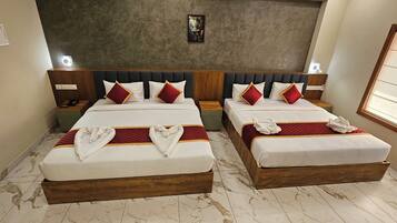 A hotel room with two beds, marble flooring, wooden headboards, and a large window.