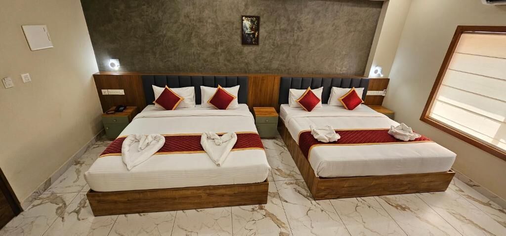 A hotel room with two beds, marble flooring, and a modern design.