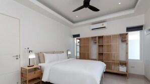 A bedroom with a bed, bedside table, lamp, wardrobe, ceiling fan, and air conditioning unit. - Orchid Paradise Homes OPV422 (Hin Lek Fai)