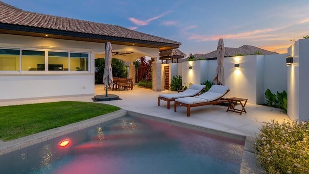 A modern house with a swimming pool, outdoor seating, and a covered patio. - Orchid Paradise Homes OPV422 (Hin Lek Fai)